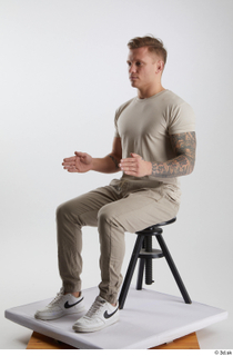 Gilbert 1 casual dressed grey t-shirt grey trousers kneeling sitting…